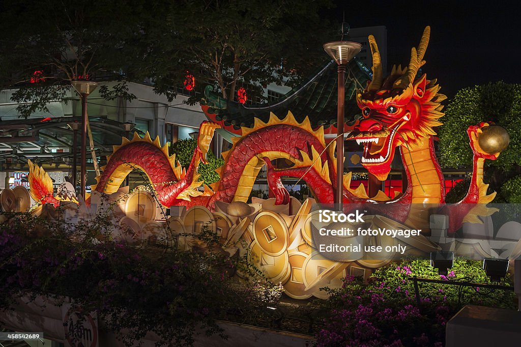 Chinese New Year dragon on overpass in Singapore Singapore, Singapore - 13th February 2012: Chinese New Year dragon and decorations overlooking the colourful fast food restaurants of Singapore's Chinatown illuminated at night. Chinese Dragon Stock Photo