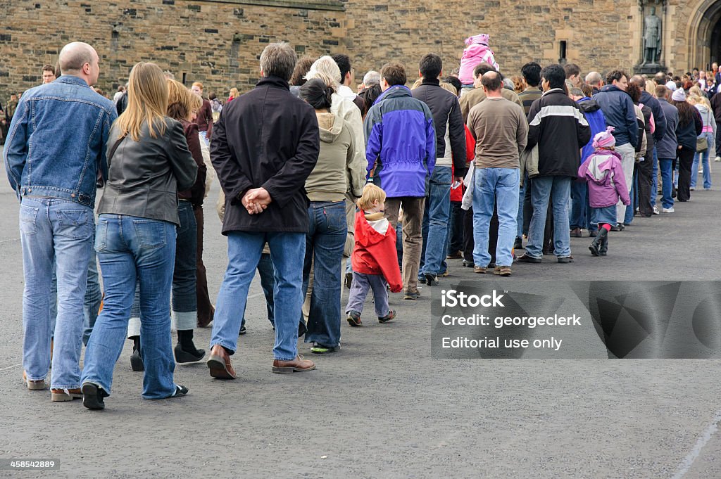 Long Queue of People Edinburgh, Scotland - April 1, 2006: Visitors queueing for entrance to Edinburgh Castle on Doors Open Day, an annual event in Scotland where access to many architectural landmarks is free of charge. Waiting In Line Stock Photo