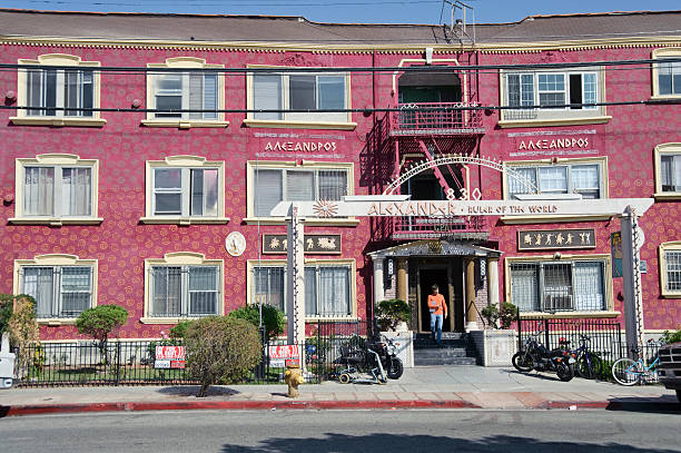 Alexander; ruler of the world Los Angeles, California, USA - September 19, 2011: A man exits from 830 N. Van Ness Ave. in Los Angeles California is a lavishly painted and decorated apartment building built in 1927 by Paramount Studios. paramount studios stock pictures, royalty-free photos & images