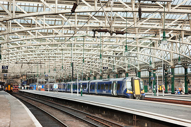 Glasgow Central Station Glasgow, UK - January 30, 2012: Scotrail trains, rail travellers and station staff at the platforms in Glasgow Central railway station, the busiest train station in Scotland and one of the busiest in the UK outside of London. The station was built in the 1870s. glasgow train stock pictures, royalty-free photos & images