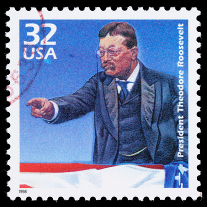 Sacramento, California, USA - March 20, 2011: A 1998 USA postage stamp with an illustration of Theodore (often Teddy) Roosevelt (1858-1919) pointing from a platform with a US flag draped over it. Roosevelt served as the 26th President of the US from 1901-1909, becoming President when McKinley was assassinated in 1901.