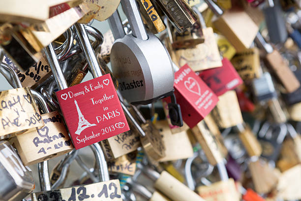 Paris, France - October 7, 2013: Love padlocks locked to the Pont des Arts bridge in Paris, France. It is a pedestrian bridge in Paris which crosses the Seine River. The love padlocks have been a phenomenon in cities around the globe.