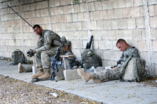Port-Au-Prince, Haiti - February 6th, 2010 : Young US soldiers take a break while on duty.The US sent their soldiers to help maintain peace and order and oversee relief operations in the earthquake hit Haiti.