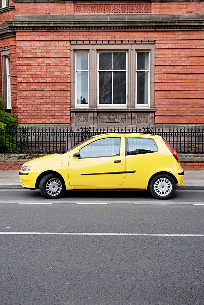 Yellow Fiat Punto car parked in Hope Street, Liverpool Liverpool, England - May 16, 2009: Yellow Fiat Punto car parked in Hope Street, Liverpool. punto stock pictures, royalty-free photos & images