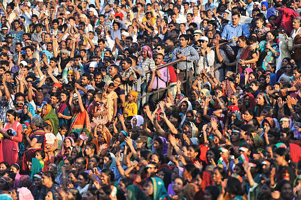 crowded Indian people Amritser, India - September 20, 2013: Indian people are exciting to see the retrect ceremony on the border between India and Pakistan, it happens at about 18:00 every eveing. india crowd stock pictures, royalty-free photos & images