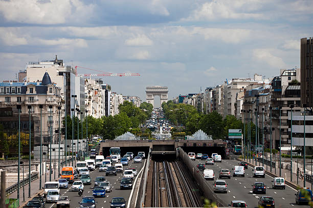 Paris, France - July, 15th 2010: Traffic on Charles de Gaulle Avenue, view from La Defense- Paris financial district, toward Arc de Triomphe seen in background