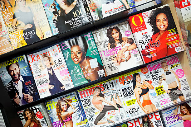 Stack of magazines New York City, USA - October 1, 2013: Stack of popular magazines on the outside of the street side newsstand on Broadway Upper West. The Oprah Magazine, Ebony, Essence, Women Health and fitness magazines can be seen. newspaper titles stock pictures, royalty-free photos & images