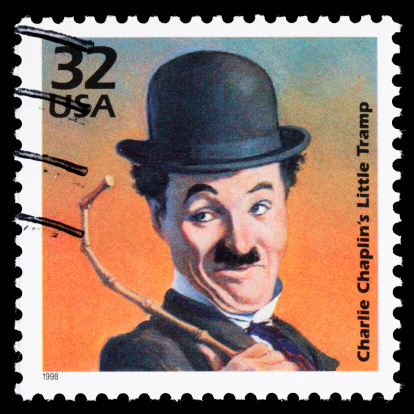 Sacramento, California, USA - March 19, 2011: A 1998 USA postage stamp with an illustration of Charlie Chaplin dressed as his Little Tramp character. Chaplin (1889-1977) first donned the Tramp's iconic clothes, hat, cane, and mustache in a 1914 film. Charles Chaplin and The Little Tramp are registered trademarks of Bubbles, Inc., S.A.