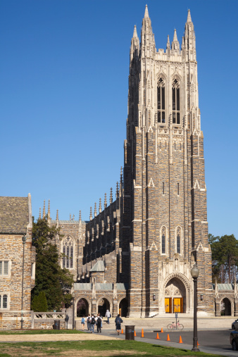 Durham, USA - March 18, 2011: Duke University Chapel and it's imposing bell tower in the morning with several undergraduate students walking to class at another part of the campus on one of the warmer days of spring.