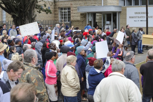 Underberg, South Africa - October 22, 2013 -A crowd of over five hundred citizens  arrived at court to protest as suspects in the brutal slaughter of Dan Knight make first court appearance.
