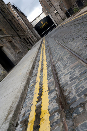 Dublin, Ireland - 23 Jun, 2007: A cobble stone street leading to the dreyman\'s entrance of St James Gate brewery in Dublin where the traditional Irish stout beer has been brewed since 1759.