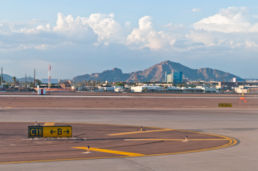 Phoenix, United States - August 14, 2011: The runway at Phoenix's Sky Harbor  International airport  parallels Camelback Mountain in the distance.  The \