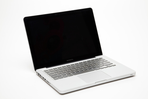 Guangzhou,Guangdong,China-March 13th,2011:the silvery MacBook Pro is manufacturing by company Apple Inc.it\'s showing the MacBook\'s display screen and keyboard,isolated on white