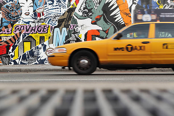 NYC yellow taxi and mural wall on Houston Street stock photo