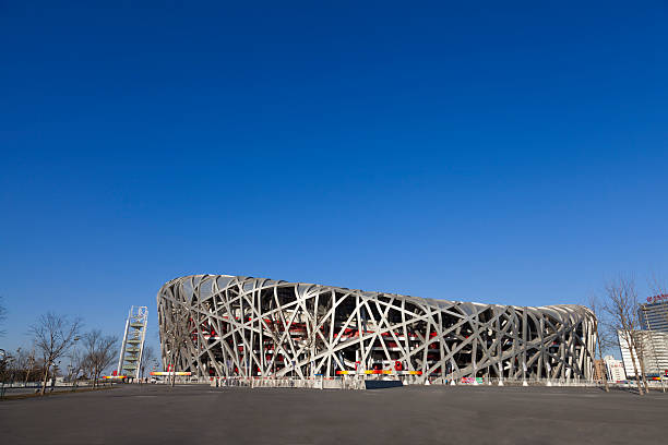 September 28, 2023 - Beijing, China: Beijing National Stadium, known as the Bird's Nest, standing illuminated at night, showcasing its distinctive steel lattice architecture as a prominent landmark and cultural symbol of China