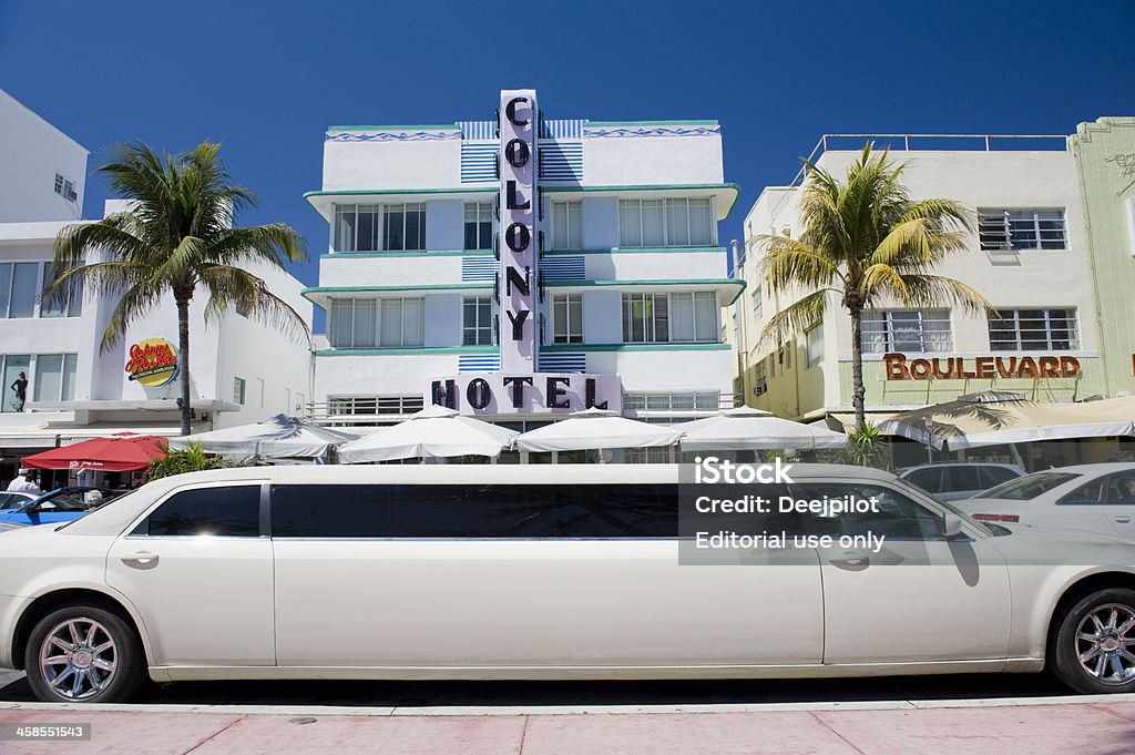 Miami Beach City Skyline in Florida USA Miami, United States - March, 11th 2011; Chrysler 300 stretched limousine parked by the Art Deco designed hotels and resturants along Ocean Drive on Miami\'s South Beach. View from Lummus Park, looking west. Art Deco Stock Photo