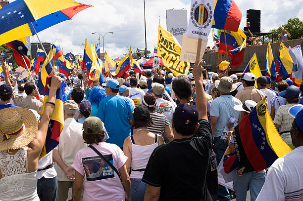 Caracas, Venezuela - Nov, 25, 2006. Protesters against Venezuelan government in a multitudinous parade supporting an opposition candidate. Multicolored view of diversity of political parties and national symbols.
