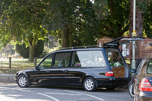 death in the family Pontesbury, Shropshire, UK - September 25th 2008. Black hearse outside Pontesbury church during a family funeral hearse photos stock pictures, royalty-free photos & images