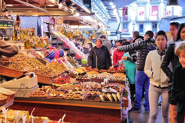 Barcelona, Spain - November 6, 2012: People visit Boqueria market on November 6, 2012 in Barcelona, Spain. Tripadvisor says it is best shopping destination in Barcelona, the most visited city in Spain.