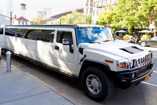 New York City, United States - September 28, 2013: A stretch Hummer Limousine car parked in Brooklyn, New York with in the background the Brooklyn Bridge.