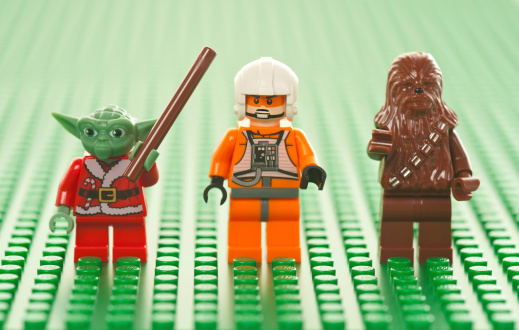 Albuquerque, USA - January 2, 2012: Lego Star Wars figures on green base plate. The Lego toys were originally designed in the 1940s in Denmark and have achieved an international appeal.