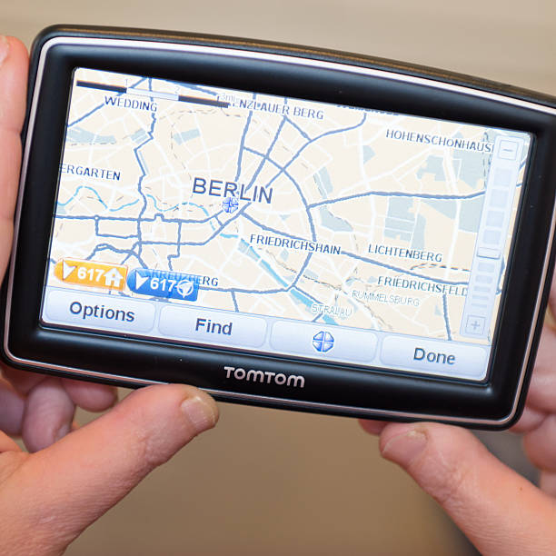 Hand holding a TomTom showing map of Berlin Florence, Italy - March 18, 2011: Woman hand holding a TomTom map with Berlin map. TomTom International BV is a Dutch company that makes satellite navigation systems for automobiles, motorcycles, handhelds and smartphones. Each system has a processor and a touch screen. TomTom is the leading supplier of navigation systems in Europe with offices around the world. The model of TomTom is XXL Europe version with 5 inch screen. guidanc stock pictures, royalty-free photos & images