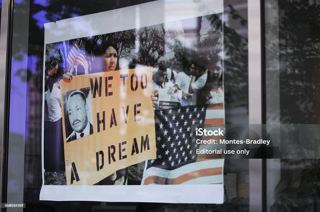 I Have a Dream, reflexion Washington, USA - July 8, 2011: The reflaction of demonstrators on a window shop. Woman carrying a pancart with the image of Dr. King and the slogan "We Too Have a Dream" in reference to woman and Litino rights. Martin Luther King Jr. Stock Photo