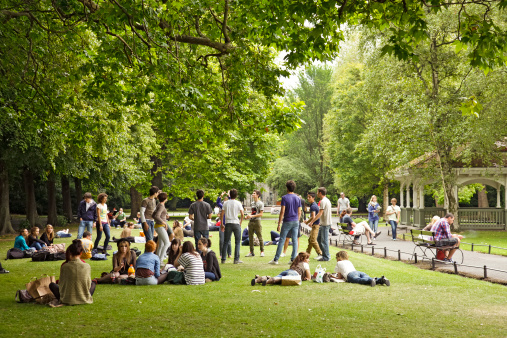 Dublin, Republic of Ireland - 13th July, 2100: Groups of visiting students (tourists) relaxing in St Stephen\'s Green, one of Dublin\'s public parks.