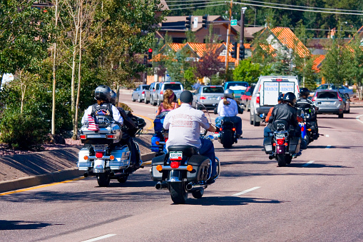 Woodland Park, Colorado, USA - July 24, 2011: Motorcycle riders head west on highway 24 through downtown Woodland Park during the Poker Run Bike Rally.