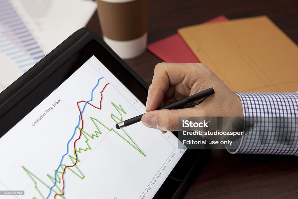 Analyzing with Digital Tablet(ipad) Tokyo japan-february 25,2011 iPad, the digital tablet with multi touch screen from Apple. Macro close up image of Ipad running financial application (stock chart) on financial annual report with hand Big Tech Stock Photo Analyzing with Digital Tablet(ipad) Tokyo japan-february 25,2011 iPad, the digital tablet with multi touch screen from Apple. Macro close up image of Ipad running financial application (stock chart) on financial annual report with hand Big Tech Stock Photo