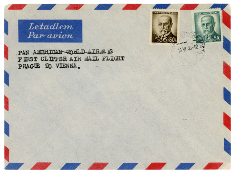 London, England - December 5, 2011: An old grey envelope with a message stating that it was on the first Pan Am Clipper airmail flight from Prague to Vienna in 1946. Pan American World Airways (Pan Am) was the largest airline in the USA until it collapsed in 1991.