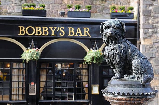 Edinburgh, Scotland, UK - April 1, 2011: Lifesize statue of Greyfriars Bobby, by William Brodie (1872). This dog was the protagonist of one of the most famous stories of Edinburgh. Greyfriars Bobby was a Skye Terrier who became known in 19th-century Edinburgh after reportedly spending 14 years guarding the grave of his owner, John Gray, until he died himself on 14 January 1872.