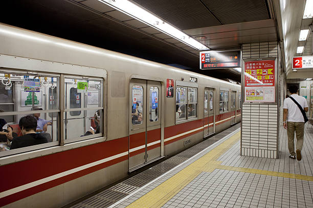 Osaka, Japan - September 9, 2011 : Osaka Municipal Subway train parked at Shinsaibashi Station. This station is located in Shinsaibashi, Chuo-ku, Osaka, Japan. Some passengers are inside the subway train and some passengers are walking at the platform.
