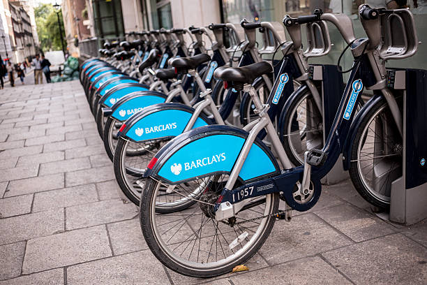 Public Bikes in London London, England - September 26, 2013: City-owned bicycles racked up and ready for commuters to rent near Charing Cross Station boris bus stock pictures, royalty-free photos & images
