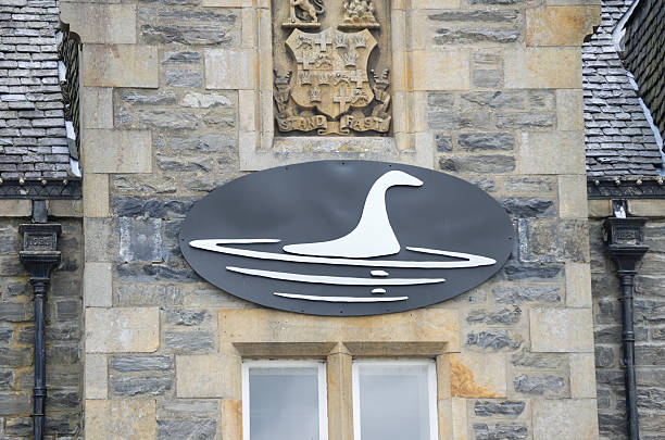 Logo of the Loch Ness Centre &amp; Exhibition Drumnadrochit, Scotland - July 31, 2011: Close up of the logo on the building of the Loch Ness Centre &amp;amp;amp;amp;amp;amp;amp;amp;amp;amp;amp; Exhibition. The exhibition was opened by the explorer Sir Ranulph Fiennes and it takes visitors on a multimedia tour to unravel the mystery of the famous Loch Ness monster. drumnadrochit stock pictures, royalty-free photos & images