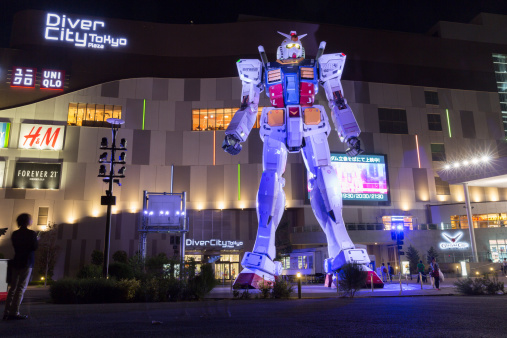 Tokyo, Japan - September 27, 2013: People at Odaiba, Tokyo, Japan. A life sized Gundam displayed in front of the DiverCity Tokyo Plaza. The world's first permanent Gundam entertainment facility is in the DiverCity Tokyo Plaza.