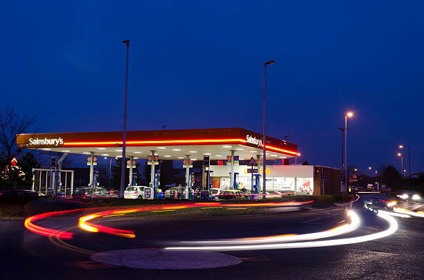 von sainsbury's tankstelle in der dämmerung, vereinigtes königreich - floodlight blue sky day stock-fotos und bilder