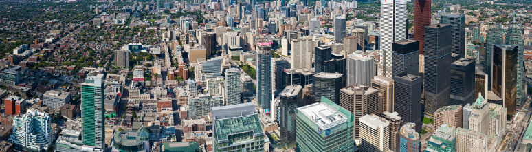Toronto, Canada - September 14th, 2011: Aerial view over the crowded city blocks, streets and skyscrapers of downtown Toronto, from the low rise buildings of Chinatown, past the Art Gallery of Ontario to City Hall, the high rise towers of the financial district to Union Station. Composite panoramic image created from thirteen contemporaneous sequential photographs.
