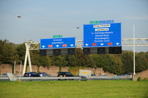 Utrecht, the Netherlands - September 29, 2011: Cars on highway A12, southwest of Utrecht, with directional signs.