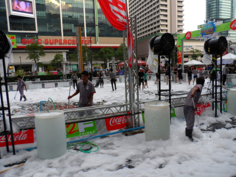 Bangkok, Thailand aa April 14, 2013: People cleaning the area filled with foam after the Songkran celebration in front of Central World (opposite Big C Supercenter), Bangkok, Thailand. One of the main celebrations during the festival is throwing water at each other.