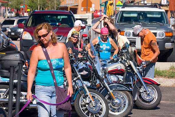 Poker Run Bike Rally Woodland Park, Colorado, USA - July 24, 2011: Line of Motorcycles parked on Midland Street in Woodland Park, Colorado with bikers looking on as they prepare for the annual Poker Run Biker Rally. woodland park zoo stock pictures, royalty-free photos & images