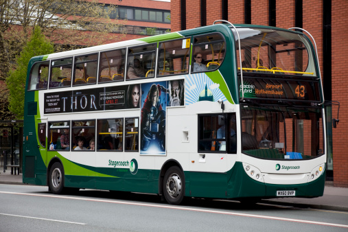 Manchester, UK - April 16, 2011: Electric hybrid double-decker bus, operated by Stagecoach, on Oxford Road, Manchester, en route to Manchester Airport. These new buses are fitted with Euro 5 engines, meeting the 'super clean' standard recommended by the European Commission, and emit 30% less carbon than standard vehicles.