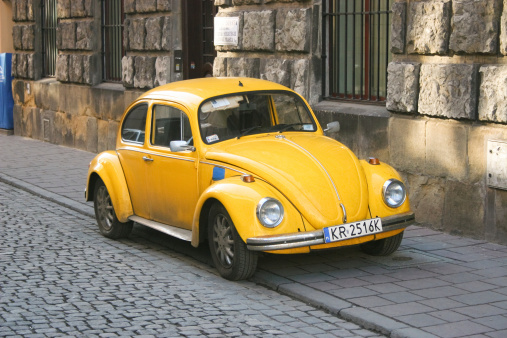 Krakow, Poland, March 3rd 2009: Old fashioned car parked on Krakow old town street. The Volkswagen Type 1, widely known as the Volkswagen Beetle, was an economy car produced by the German auto maker Volkswagen (VW) from 1938 until 2003.