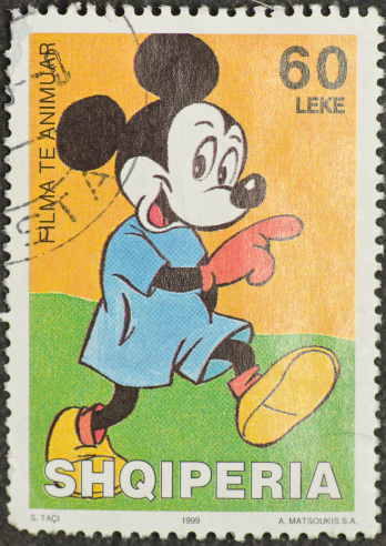 Salt Lake City, Utah, USA - Feb 5th, 2011: A 1999 Albanian postage stamp with Mickey Mouse on it. Mickey Mouse's appearance and the words Mickey Mouse are registered trademarks of The Walt Disney Company.