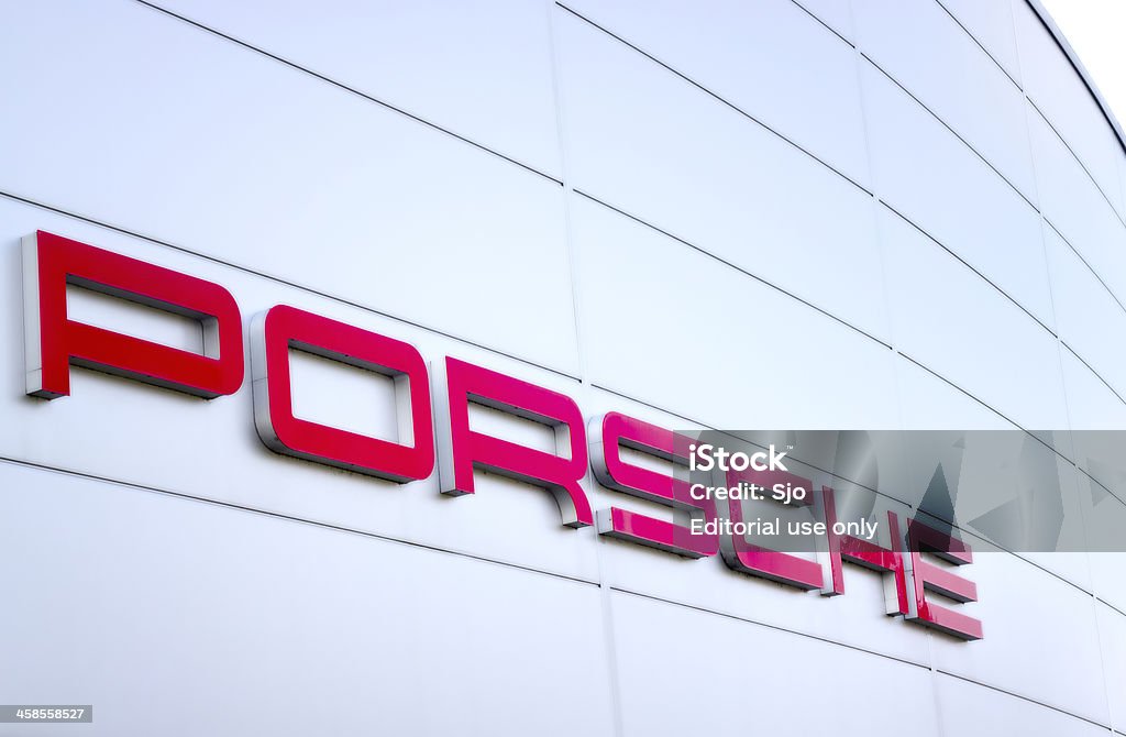 Porsche sports car manufacturer logo outside a dealership Leusden, The Netherlands - March 15, 2011: Red Porsche logo at the Pon dealership. Porsche Stock Photo