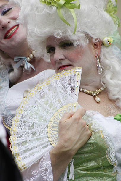 Drag Belles New Orleans, LA, USA aa March 08, 2011: Men in drag are costumed for Mardi Gras as ladies of the court of Marie Antoinette and parade through the streets of the French Quarter. mardi gras body painting stock pictures, royalty-free photos & images