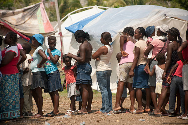 Poor African children keeping their cupped hands up, asking for help. Many African children suffer from poverty, diseases, contaminated water and malnutrition.