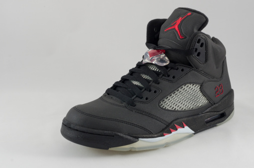Bergen County New Jersey, USA - September 8, 2013: A Nike Air Jordan V shown here in a black colorway on a white background. The Air Jordan V was originally released in 1990 and re-released in: 2000, 2006, 2007, 2008, 2009, 2011 and 2013.