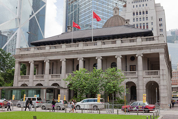 Hong Kong, China - July 22, 2011: Pedestrians walk pass the road in front of the Legislative Council Building in Central District, Hong Kong. Legislative Council will move in September to the new Central Government Complex in the Admiralty area of Hong Kong. The current building will house the Court of Final Appeal.