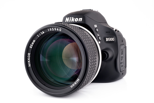 Chiang Mai, Thailand - May 3, 2011: Nikon D5100 DLSR camera with an older manual focus 85mm f1.4 lens.  This image demonstrates how old lenses can be used with modern Nikon camera bodies.